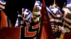 A supporter of Greece's far-right Golden Dawn party salutes in a Nazi style during a rally at central Syntagma square in Athens